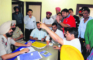 A BJP leader argues with police officials at bus stand police chowki in Amritsar on Thursday
