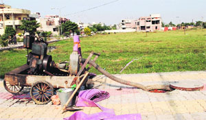 A power generator pumps out sewage on an open patch of land at New Amritsar locality in Amritsar on Thursday. 