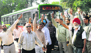 Auto-rickshaw operators block the way of a CTU bus during their strike at Phase VI in Mohali on Thursday