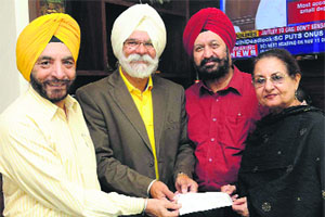 (From left) Balbir Singh Mangat, honorary secretary, BS Gill, president, Dr GS Kochhar, chairman, corporate social responsibility, and Jyoti Singh, chairman, bar and catering house sub-committee, respectively, of the Chandigarh Golf Club, give a cheque for Rs 9.58 lakh towards the J&K relief fund at The Tribune office in Chandigarh on Thursday.