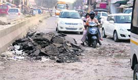 The stretch of the badly worn-out Garha Road in Jalandhar on which repair work started on Thursday.