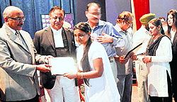Justice Hemant Gupta (L) hands over licences to students at Law Bhawan in Sector 37, Chandigarh, on Thursday