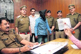 SP city (right) presents the accused at a press conference in Dehradun on Thursday