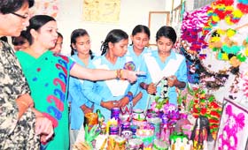 Girl students hailing from poor families display artefacts made by them from dumped articles at Government Girls College in Haridwar on Thursday