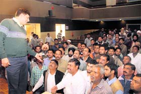 Shopkeepers of Transport Nagar protest in front of MDDA secretary Bansidhar Tiwari at the Town Hall in Dehradun on Thursday