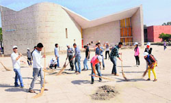 Students during a cleanliness drive at the PU on Friday. Tribune photo: Manoj Mahajan