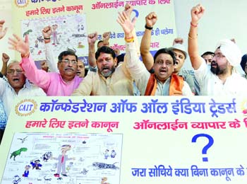 Activists of the Confederation of All India Traders shout slogans, demanding investigation into the business modules of online retail platforms and their pricing mechanism, at Jantar Mantar on Friday.