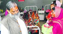 Anil Vij talks interacts with a patient at the Lok Nayak Jai Prakash Hospital in Kurukshetra on Friday.