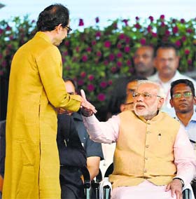 Prime Minister Narendra Modi with Shiv Sena chief Uddhav Thackeray at the swearing-in ceremony in Mumbai on Friday.