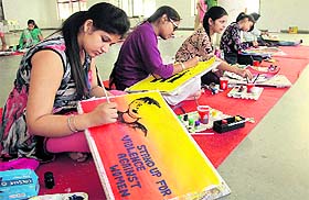 Girls participate in a painting competition during second day of Mela Gadri Babeyan Da at Desh Bhagat Hall in Jalandhar on Friday. 