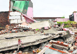 Houses damaged by the recent floods in the Jammu region. a tribune FILE Photo