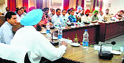 AS Pannu, Divisional Commissioner, Patiala Division, interacts with officials and political leaders during a meeting at Bachat Bhawan in Ludhiana on Friday