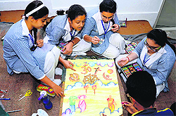 Children prepare a poster at BCM School in Ludhiana