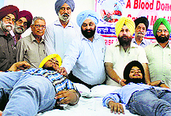 A volunteer donates blood at Guru Nanak Dev Engineering College in Ludhiana on Friday