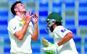 Mitchell Marsh is frustrated as Younis Khan runs a single en route his double hundred in Abu Dhabi on Friday. 