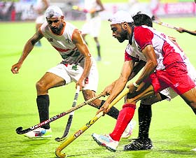 The players of Punjab Police and Indian Navy vie for the ball during their contest in Surjit Hockey in Jalandhar. 