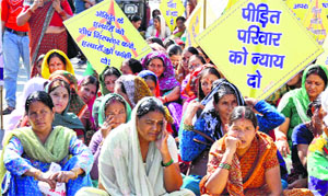 Residents of Nakronda village stage a dharna near the police headquaters in Dehradun on Friday.