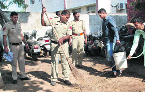 Police personnel clean a police station  during a cleanliness drive at the MDC in Panchkula on Saturday.