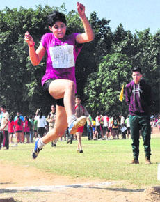 A girl takes part in the long jump event during the CBSE Cluster XIII Athletics Meet 2014-15 at the sports complex in Sector 46, Chandigarh, on Saturday.