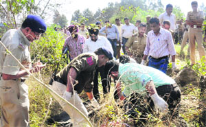 Forensic experts and police officials examine the spot in Chandigarh on Saturday.