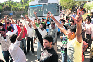 Protesting auto drivers stop a CTU bus at the MDC in Panchkula on Saturday.