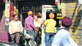 Youths forcibly shut shops during the Punjab bandh in Jalandhar on Saturday.
