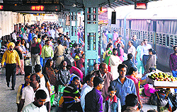 Passengers wait for their trains