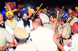 Activists argue with policemen as they are stopped from blocking rail traffic in Amritsar
