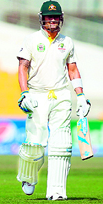 Michael Clarke walks off the pitch after he was bowled out by Imran Khan during the third day of the second Test at the Zayed International Cricket Stadium in Abu Dhabi