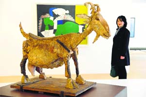 A visitor looks at a Picasso sculpture and paintings during the press day at the Picasso Museum in Paris