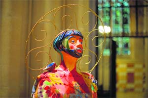 A decorated fiberglass sculpture in prayer is displayed at the Cathedral Church of Saint John the Divine in New York