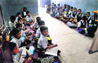 Students of the junior wing of Government Senior Secondary School, Dhanas, wait for their teacher to turn up in the class.