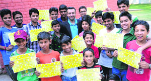 Slum children show certificates received by them after attending a free handwriting workshop organised by handwriting and signature expert Puneet Sachdeva in Sector 24, Chandigarh, on Sunday.