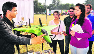 Visitors enquire about a working model of an aircraft during PECFest in Chandigarh on Sunday