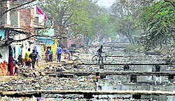 An open drain is littered with plastic bags in the NIT area of Faridabad