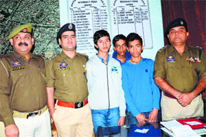 Police personnel with the three children who were recovered from Dehradun at the Residency Road police station in Jammu on Sunday. 
