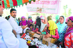 A file photo of women receiving medicines at a medical camp organised by the Indian System of Medicines for flood victims in Srinagar. 