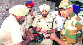 Army and police officers inspect the ammunition.
