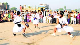 Gatka artistes perform during a nagar kirtan taken out ahead of the birth anniversary of Guru Nanak Dev in Muktsar on Sunday.