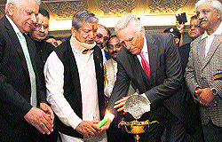 Chief Minister Harish Rawat and Simon Cooper light a lamp during the inaugural ceremony of the hotel in Mussoorie on Saturday