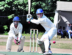 An Uttarakhand Police batsman plays a shot during a match in the Nazar Khan Memorial Cricket Tournament at Rangers Ground in Dehradun