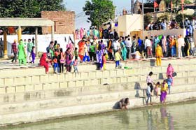 Devotees take a holy dip in the sarover at Ram Tirath in Amritsar