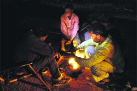 Mercury dips: People sit around a bonfire to keep themselves warm on a chilly night in Amritsar