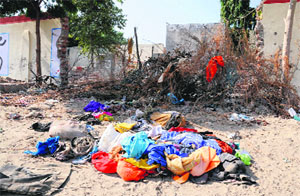 A view of the garbage thrown by the residents and passersby inside the breached boundary wall of Government Rajindra College in Bathinda on Monday