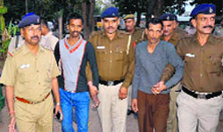 The two accused, Ajay and Manik, in police custody at the Phase I Industrial Area police station in Chandigarh on Monday. A Tribune photograph 