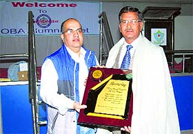 Tarun Malhotra, president, Old Students Association of Sainik School, honours a teacher on the foundation day of the school at Sujanpur Tihra in Hamirpur on Monday.