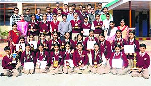 Students of Greenfield Public School pose with their trophies and school staff after winning the district-level science competition at Nagrota Surian in Kangra on Monday.
