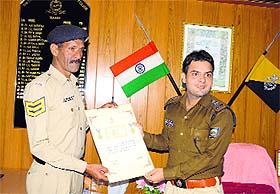 Superintendent of Police Mohit Chawla honours constable Krishan Chand in Mandi on Monday. 
