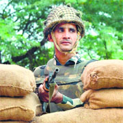 A BSF man guards the border at Wagah on Monday.