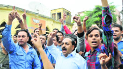 BJP workers protest ticket distribution at the party office in Jammu on Monday. Tribune Photo: Inderjeet Singh